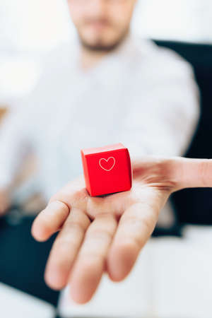 hand man giving a gift in a red boxの写真素材