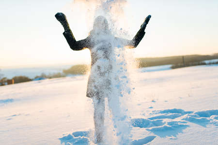 happy girl playing in the snow, snow on faceの写真素材