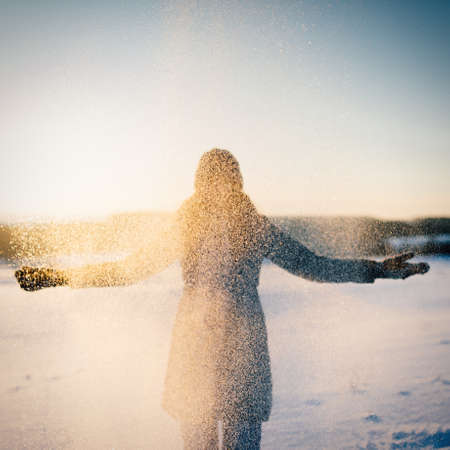 happy girl playing in the snow, snow on faceの写真素材