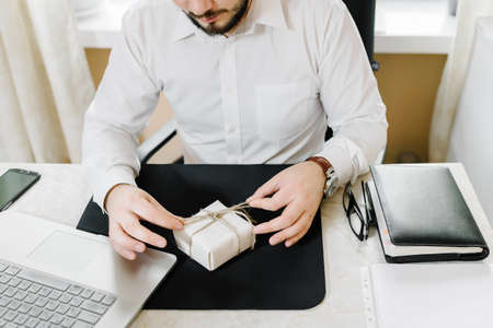 Business man in white shirt is preparing a gift for women employeesの写真素材