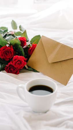a bouquet of red roses coffee card with congratulations supply in bedの写真素材