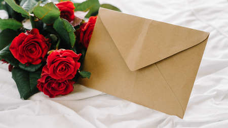 a bouquet of red roses coffee card with congratulations supply in bedの写真素材