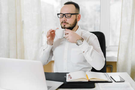businessman drinking coffee in the workplaceの写真素材