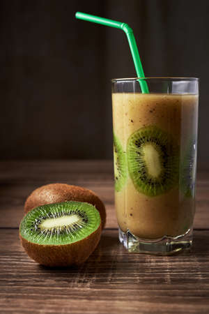 Healthy fresh kiwi cocktail in a glass on a wooden background, sliced kiwi in a glassの写真素材