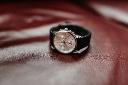 Men's wristwatch on the leather surface, attire for the groomの写真素材