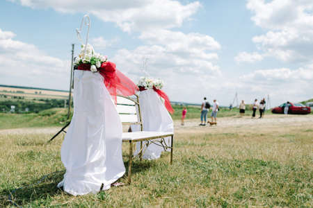 A bench for guests decor at a wedding, outdoorsの写真素材