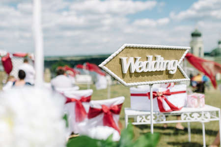 Wedding decor. Wooden plaque with the inscription Wedding. Wedding on a plate green background and a fountain. Wedding decorations,の写真素材