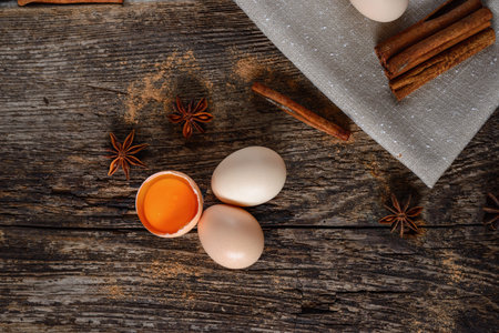 Eggs, cinnamon, baden on an old wooden backgroundの写真素材