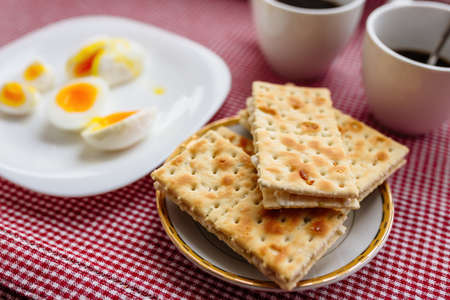 Two cups of coffee, cracker, egg, breakfastの写真素材