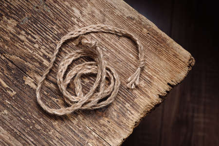 Woven rope on an old wooden table, decorの写真素材