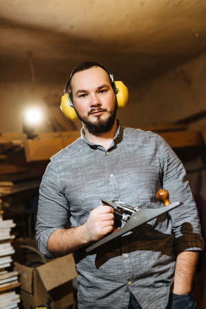 Carpenter, in the workshop at work working with woodの写真素材