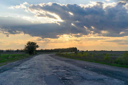 Picturesque landscape scene and sunrise above roadの写真素材
