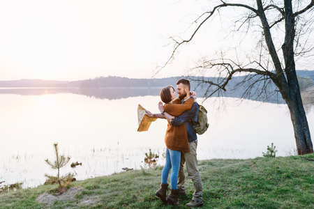Happy couple on vacation hiking in the mountains with a mapの写真素材
