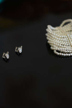 Decoration on the bride's hand, white pearls on a black backgroundの写真素材