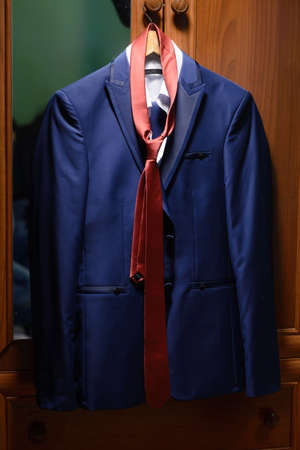 men's blue jacket with an orange tieの写真素材