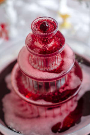 alcoholic fountain of red color, buffet tableの写真素材