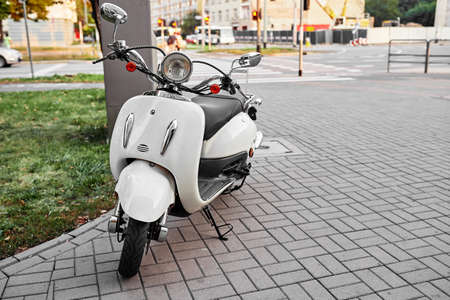 Retro scooter on a beautiful narrow street in the old city of white colorの写真素材