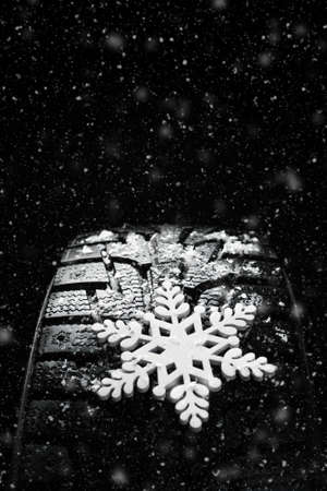 Winter tires. Tires for winter with snow on a black backgroundの写真素材