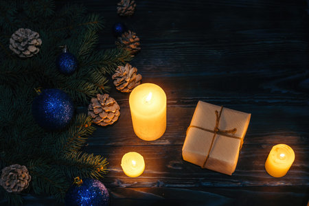 Christmas and Christmas decorations Pine branches of a tree, cones, blue Christmas toys on a wooden...