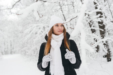 Beautiful young girl in a white fairy winter forest. walk in the fresh air
