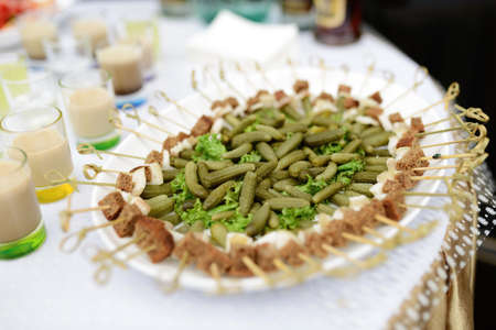 small marinated cucumbers on a buffet tableの写真素材