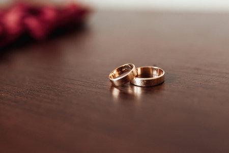 two gold wedding rings isolated on a wooden background, wedding rings background concepts