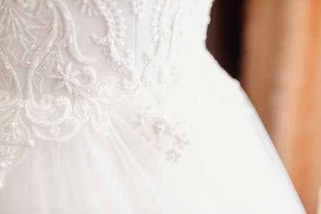 Beautiful wedding dresses on a mannequin, details close-upの写真素材
