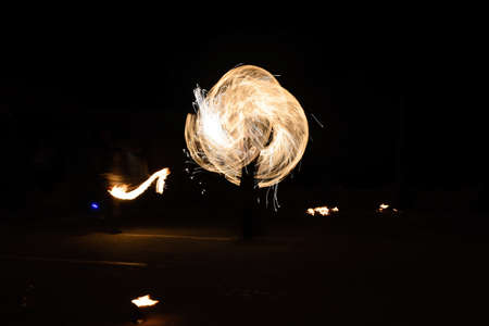 fire show and a lot of the bright sparks in the nightの写真素材