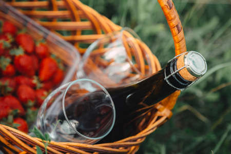 strawberry, wine bottle and glasses for wine in a picnic basket - close-up imageの写真素材