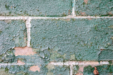 old stone texture green in a cage, spoiled by time