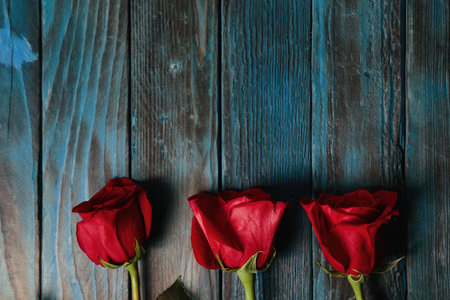 beautiful bouquet of red rose flowers on old blue wooden background, horizontal.