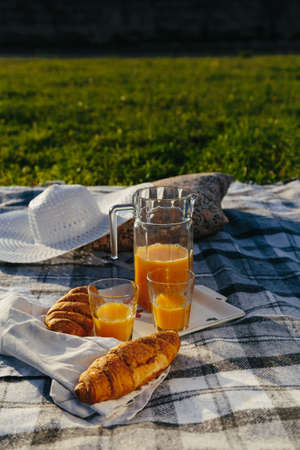 Tasty continental breakfast with fresh puff croissants, orange juice, closeup on croissantsの写真素材