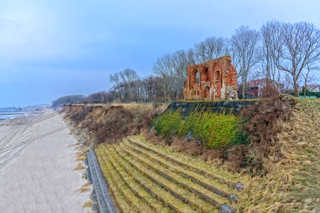 The ruins of the church in Trzesacz beach Baltic Sea coastの写真素材