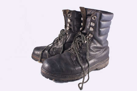 two old soldiers shoes on white backgroundの写真素材