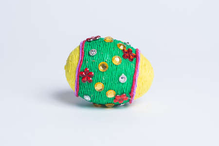 Easter egg with ornaments lying on a white backgroundの写真素材
