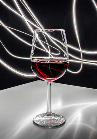 Glass of red wine on a black backgroundの写真素材