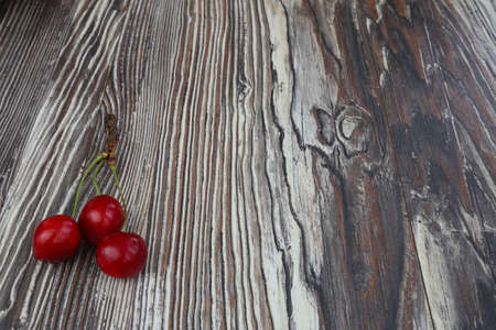 Fresh red Cherries on wooden table macro backgroundの写真素材