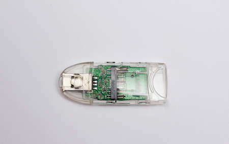 A device for reading memory cards in a translucent casing isolated against a white background.の写真素材