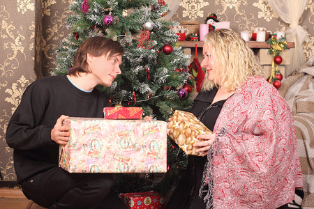 A woman and a man give each other presents for Christmas.の写真素材