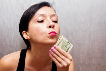 Beautiful brunette woman expresses her love for money.