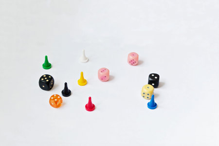 Game pieces of different colors and dice for Board game isolated on a white background.