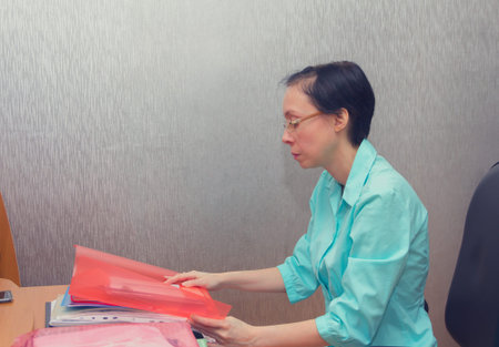The woman is going to work with documents.の写真素材
