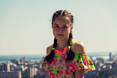 Portrait of a teenage girl on the background of a big city.