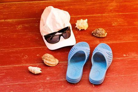 Summer beach holiday items and accessories on wooden surface.