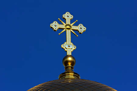 A golden cross on the dome of an Orthodox Christian church.の写真素材