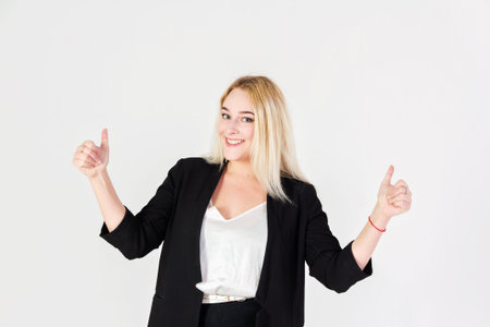 Studio portrait of smiling girl isolated on white background. Reference with thumbs up gestures.