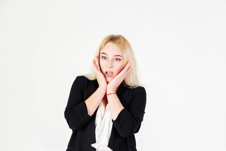 Studio portrait of blonde girl isolated on white background. Reference of a frightened and surprised...