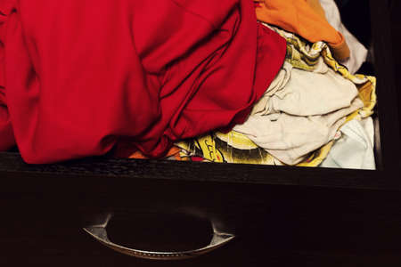 Open chest of drawers with a variety of household linen.の写真素材