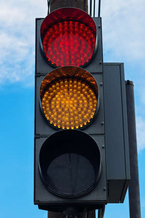 Modern LED traffic light with two light indications yellow and red.の写真素材