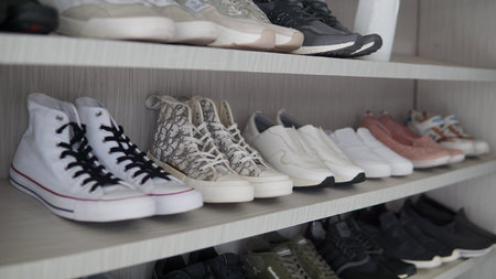Shelves with different types of sports shoes. Shallow depth of field.の写真素材